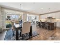 Bright dining room with hardwood floors, pendant lighting and sliding doors to backyard at 25190 E Nova Pl, Aurora, CO 80016