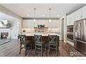 Open kitchen featuring a large island, stainless steel appliances, and stylish pendant lights at 25190 E Nova Pl, Aurora, CO 80016