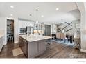 Spacious kitchen with a large island, stainless steel appliances, and ample cabinet space at 25190 E Nova Pl, Aurora, CO 80016