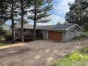 Cozy single-story home with a two-car garage and wood deck, offering a comfortable living space nestled in a wooded area at 258 Post Boy Rd, Boulder, CO 80302