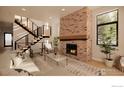 Bright living room with a brick fireplace, open staircase, and large windows providing plenty of natural light at 2941 21St St, Boulder, CO 80301