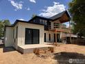 Modern home exterior features a large deck, outdoor living space, and sleek white siding at 2941 21St St, Boulder, CO 80304