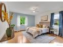 Cozy bedroom with hardwood floors, a large window, and a comfortable bed with plush bedding at 3300 Bridger Trl # 111, Boulder, CO 80301