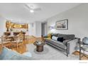 Open concept living area with gray sofa, dining area, and view of the kitchen at 3300 Bridger Trl # 111, Boulder, CO 80301