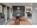 Dining area featuring a glass table and stylish chairs adjacent to sliding glass doors at 3335 Chisholm Trl # 202, Boulder, CO 80301