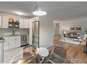 Open-concept area showcasing a kitchen and living room with modern decor and appliances at 3335 Chisholm Trl # 202, Boulder, CO 80301