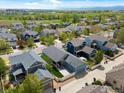 Scenic aerial view of a blue house in a friendly neighborhood with green spaces at 569 Jackson St, Lafayette, CO 80026