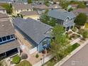 Birds eye view of a blue house showcasing its backyard and surrounding neighborhood at 569 Jackson St, Lafayette, CO 80026