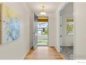 Inviting entryway boasting hardwood floors and an open doorway, revealing the home's exterior at 687 Jarvis Dr, Erie, CO 80516