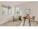 Bright office with a neutral color palette, two windows, and a comfortable chair and desk set at 687 Jarvis Dr, Erie, CO 80516