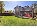 Large grassy backyard featuring a patio, perfect for outdoor entertaining and activities at 711 Hawthorn Ave, Boulder, CO 80304