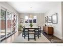 Bright dining room featuring a modern table, chairs, light fixture, and sliding glass door at 711 Hawthorn Ave, Boulder, CO 80304
