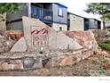 Community signage for Tantra Lake Apartments with stone accents in landscape at 750 W Moorhead Cir # A, Boulder, CO 80305