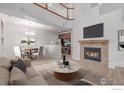 Inviting living room with a cozy fireplace, modern furnishings, and an open floor plan at 7777 E 23Rd Ave # 1406, Denver, CO 80238
