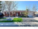Inviting brick home with a well-maintained lawn and walkway at 8089 Greenwood Blvd, Denver, CO 80221