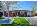 Beautiful brick house with front yard featuring rock and lawn at 8089 Greenwood Blvd, Denver, CO 80221