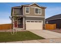 A well-maintained two-story home with a red door, two-car garage, and a lush green lawn at 816 Leeward St, Lochbuie, CO 80603
