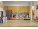 Kitchen featuring modern stainless steel appliances and a stylish backsplash at 8479 Everett Way # E, Arvada, CO 80005