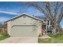 Charming home with neutral siding and brick accents, featuring a two-car garage and mature landscaping at 9125 W 95Th Ave, Westminster, CO 80021