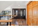 Bright entryway with tiled flooring, staircase with modern railings and a stylish double front door at 98 Rim Rd, Boulder, CO 80302