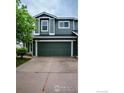 Two-story home showcasing the garage and driveway at 11040 York St, Northglenn, CO 80233