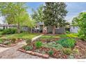 Charming single-story home with landscaped front yard and inviting red door at 1343 Gay St, Longmont, CO 80501