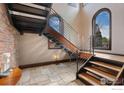 Modern wood and steel staircase with large windows providing natural light at 1376 S Clayton St, Denver, CO 80210