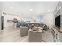 Open-concept living space with a kitchen, living room with fireplace, and large windows offering great views at 14762 Charbray St, Mead, CO 80542