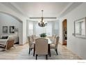Elegant dining room with tray ceilings, decorative chandelier, and bay window seating at 15453 E 109Th Ave, Commerce City, CO 80022