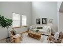 Bright living room boasts high ceilings, lots of natural light, modern decor and a cozy seating area at 15453 E 109Th Ave, Commerce City, CO 80022