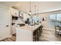 Well-lit kitchen with stainless steel appliances, spacious countertops and a breakfast bar at 16637 Promenade St, Broomfield, CO 80023