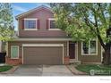 Charming two-story home with a two-car garage and a well-maintained front yard at 1684 Holeman Dr, Erie, CO 80516
