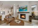 Cozy living room with a fireplace and large screen television, ideal for entertaining guests at 1933 W 165Th Way, Broomfield, CO 80023