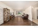 Spacious living room with hardwood floors, a large bay window, and neutral paint at 2072 Skylark Ct, Longmont, CO 80503
