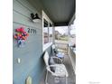 Relaxing front porch with two chairs and a small table with seating, perfect for enjoying the outdoors at 2793 Red Wheat Trl, Berthoud, CO 80513