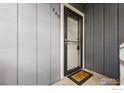 Neutral colored front door with storm door and welcome mat at 2800 Kalmia Ave # C203, Boulder, CO 80301