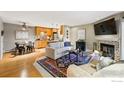 Cozy open-concept living room with fireplace and hardwood floors at 2800 Kalmia Ave # C203, Boulder, CO 80301