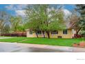 Pleasant single-story home with a well-kept lawn, surrounded by mature trees and a charming fence in the background at 3090 17Th St, Boulder, CO 80304
