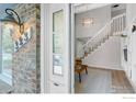 Bright entryway featuring a view of the stairway, light fixture, and living space at 323 S Hoover Ave, Louisville, CO 80027