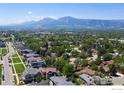 Sweeping aerial view of neighborhood with the Rocky Mountains in the distance at 3821 Howe Ct, Boulder, CO 80301