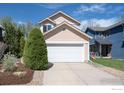 Front exterior view of home with large driveway and a well-manicured front yard at 3821 Howe Ct, Boulder, CO 80301