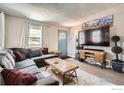 Spacious living room with comfortable seating, large TV, and stylish decor at 4009 W 52Nd Ave, Denver, CO 80212