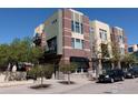 Street view of a three-story brick condo building with small trees and black awning at 4585 13Th St # 1-C, Boulder, CO 80304