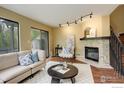 Relaxing living room with a stone fireplace and modern lighting fixtures at 4647 Dapple Ln # 1, Boulder, CO 80301