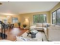 Bright open-concept living and dining area with hardwood floors and large windows at 4647 Dapple Ln # 1, Boulder, CO 80301