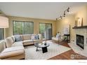 Inviting living room with a cozy fireplace, plush seating, and large windows offering natural light at 4647 Dapple Ln # 1, Boulder, CO 80301