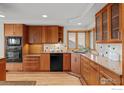 Well-equipped kitchen with custom wood cabinets, granite countertops, and modern appliances at 560 Northstar Ct, Boulder, CO 80304