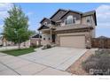 Inviting two-story home showcasing a well-manicured lawn and an attached two-car garage at 6725 2Nd St, Frederick, CO 80530