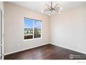 Bright office space featuring hardwood floors, a window, and stylish light fixture at 6725 2Nd St, Frederick, CO 80530