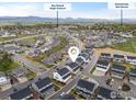 Aerial view of a residential neighborhood with a view of the mountains in the background at 685 Crossbill Dr, Berthoud, CO 80513